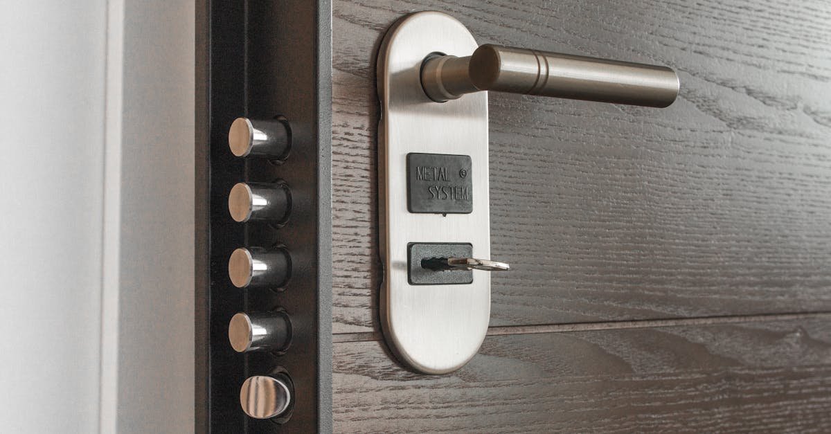 Metal door handle and lock system with key inserted, showcasing security features.